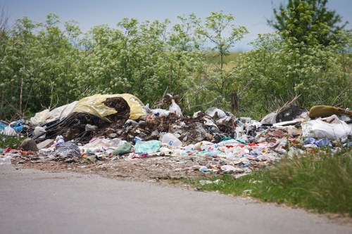 Personnel wearing PPE while handling waste and skips